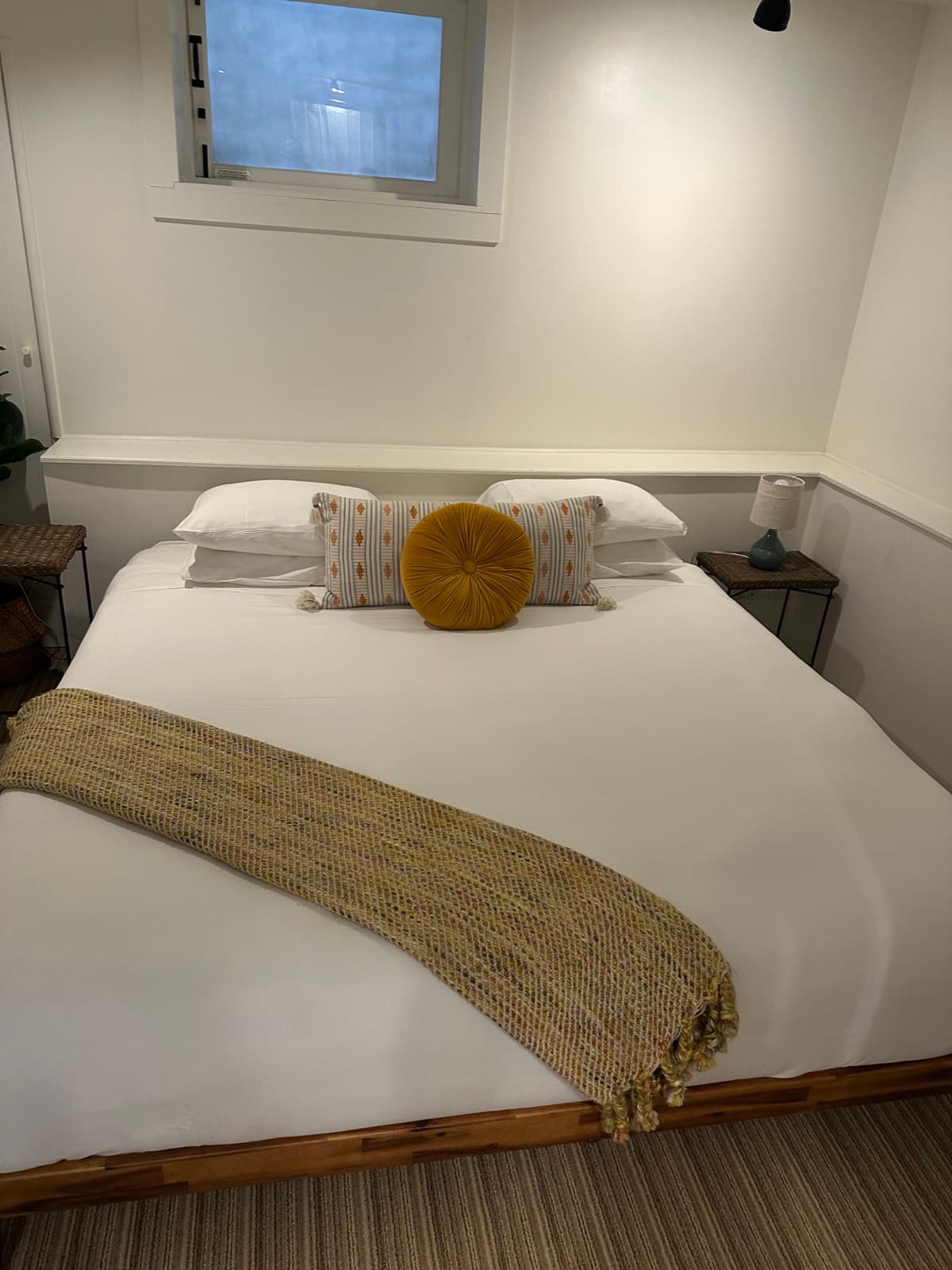 Guest-ready bedroom with white linens and decorative pillows